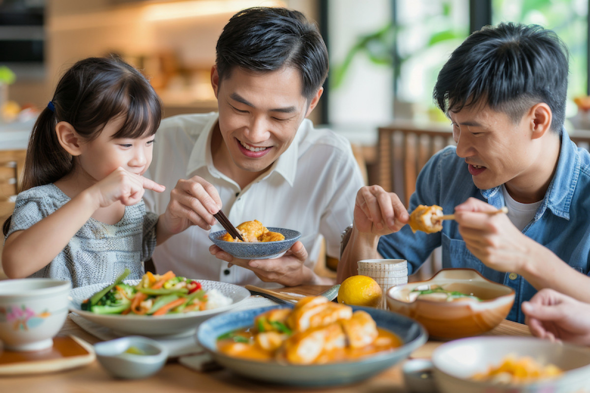 Asian family eating a meal of chicken